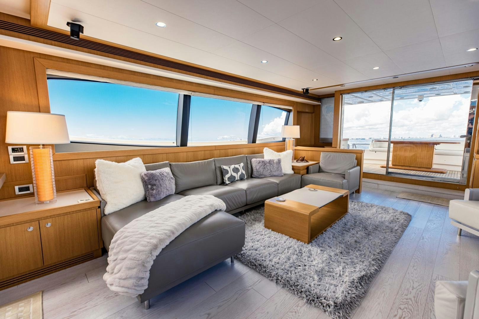 a living room with a large window aboard SHE RUNS WET Yacht for Sale