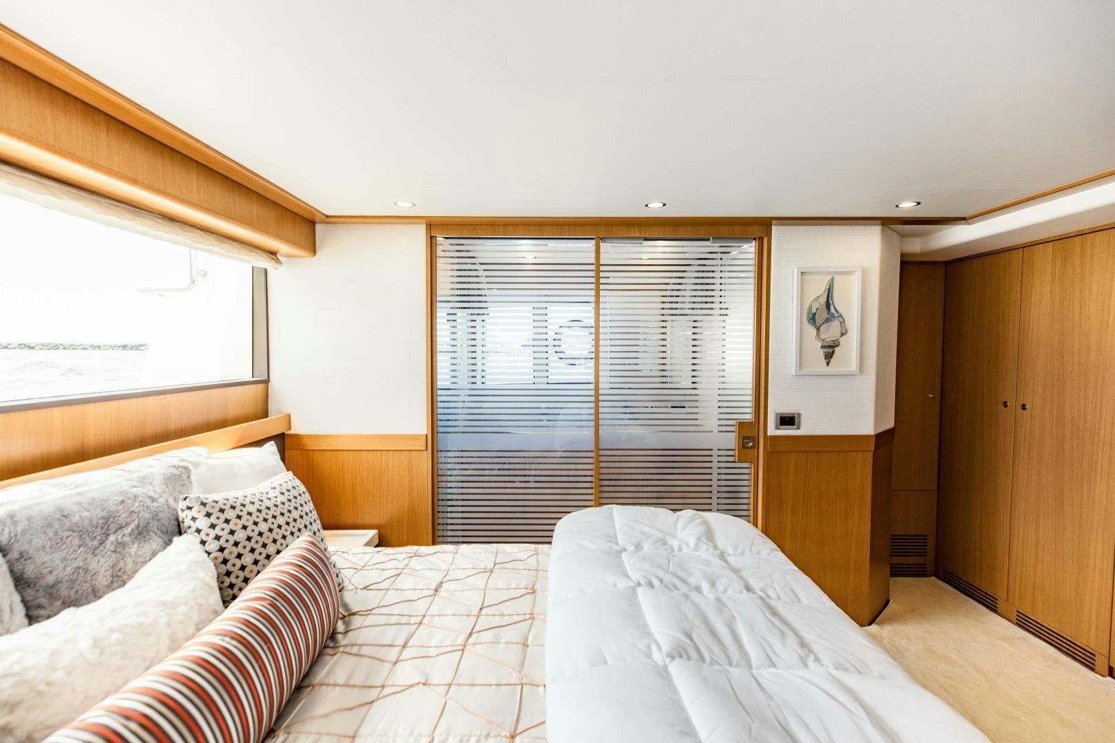 a bedroom with a bed and a window aboard SHE RUNS WET Yacht for Sale