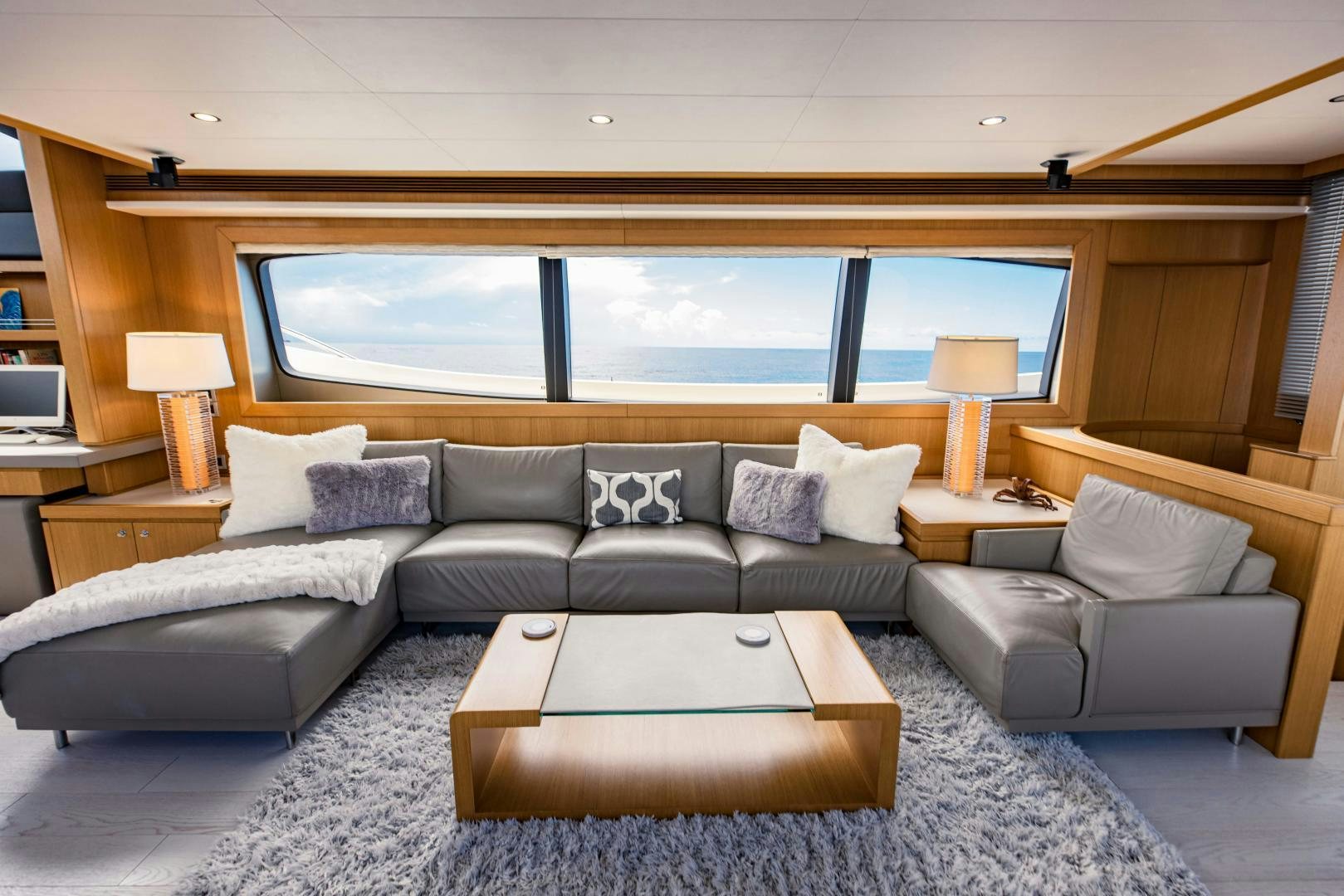 a living room with a large window aboard SHE RUNS WET Yacht for Sale