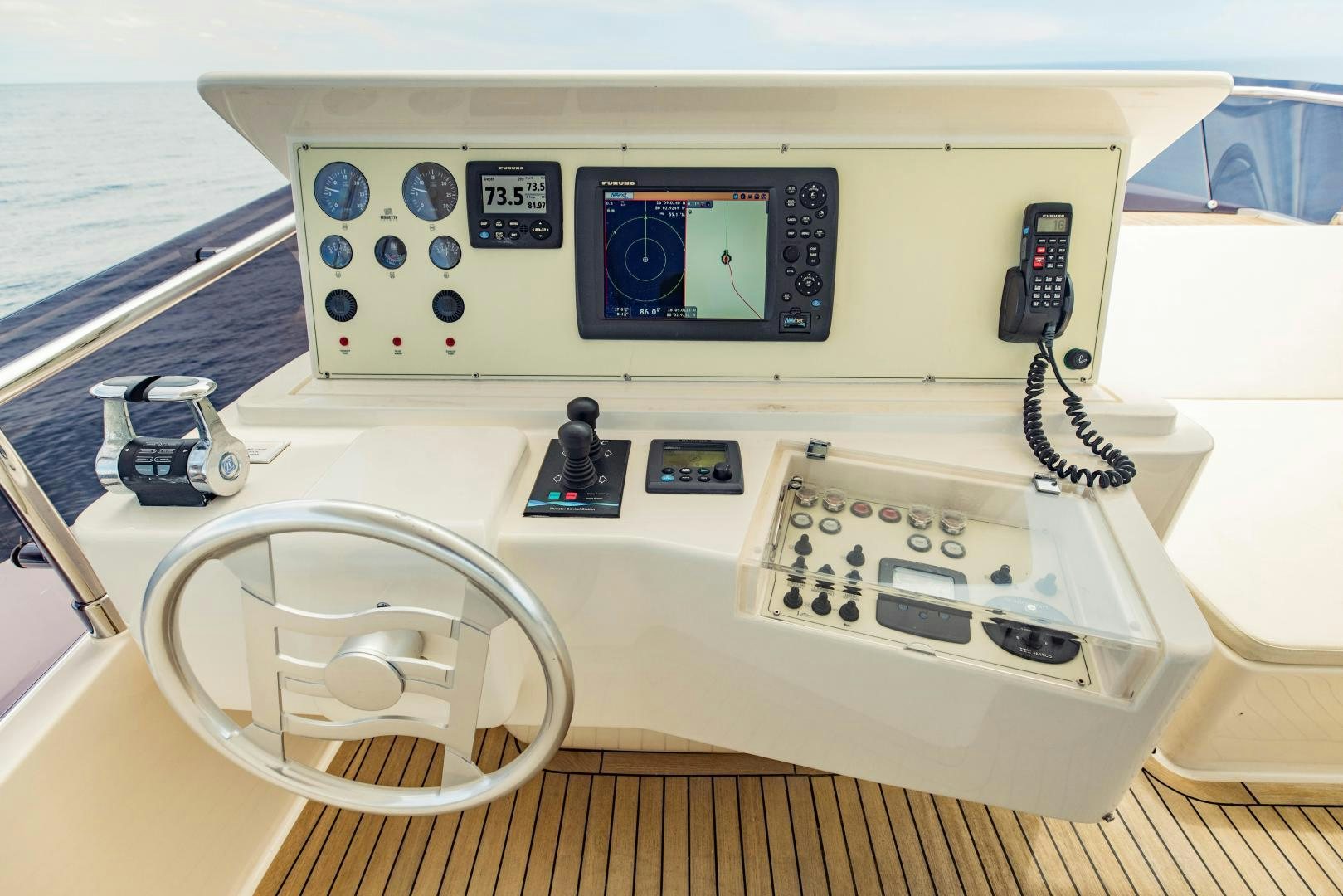 a white electronic device with a screen aboard SHE RUNS WET Yacht for Sale