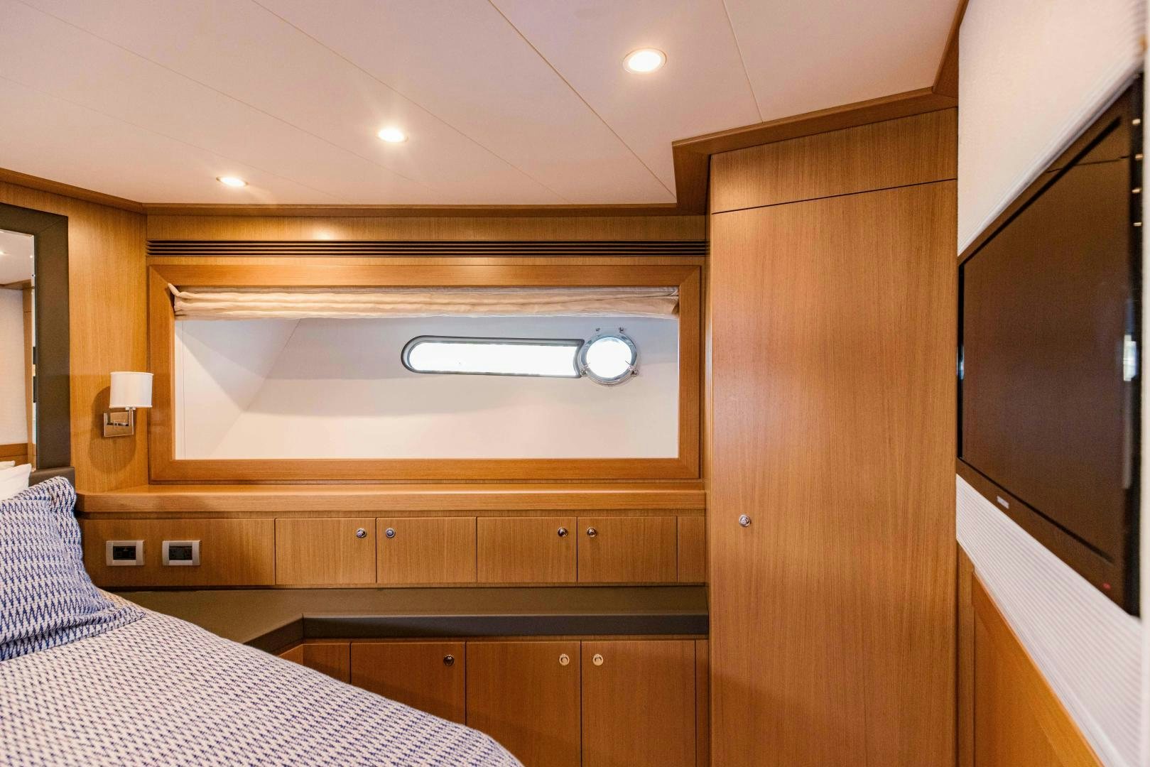 a room with a bed and a television aboard SHE RUNS WET Yacht for Sale