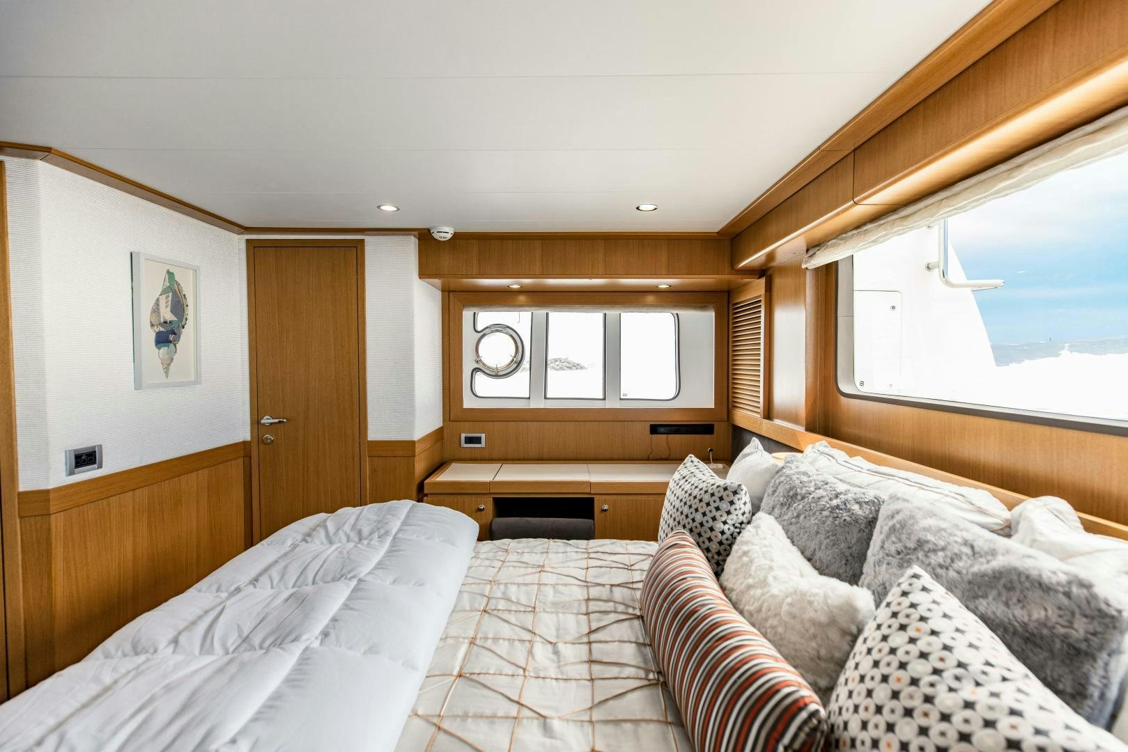 a bedroom with a bed and a window aboard SHE RUNS WET Yacht for Sale