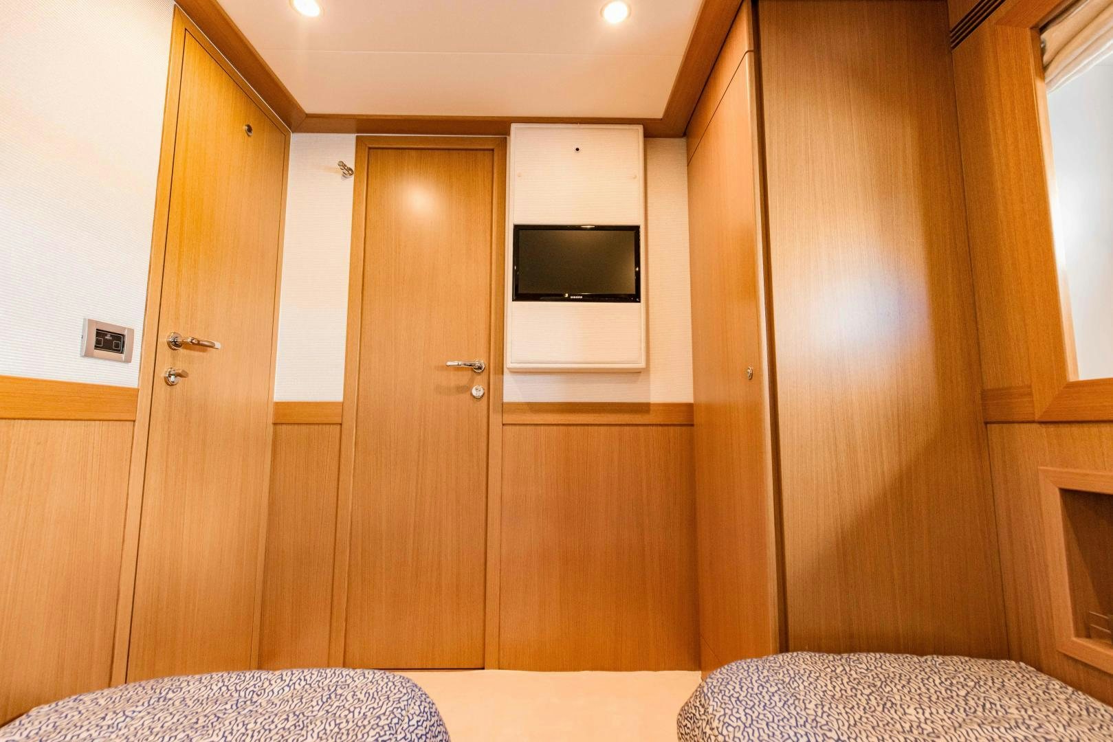 a room with a bed and a television aboard SHE RUNS WET Yacht for Sale