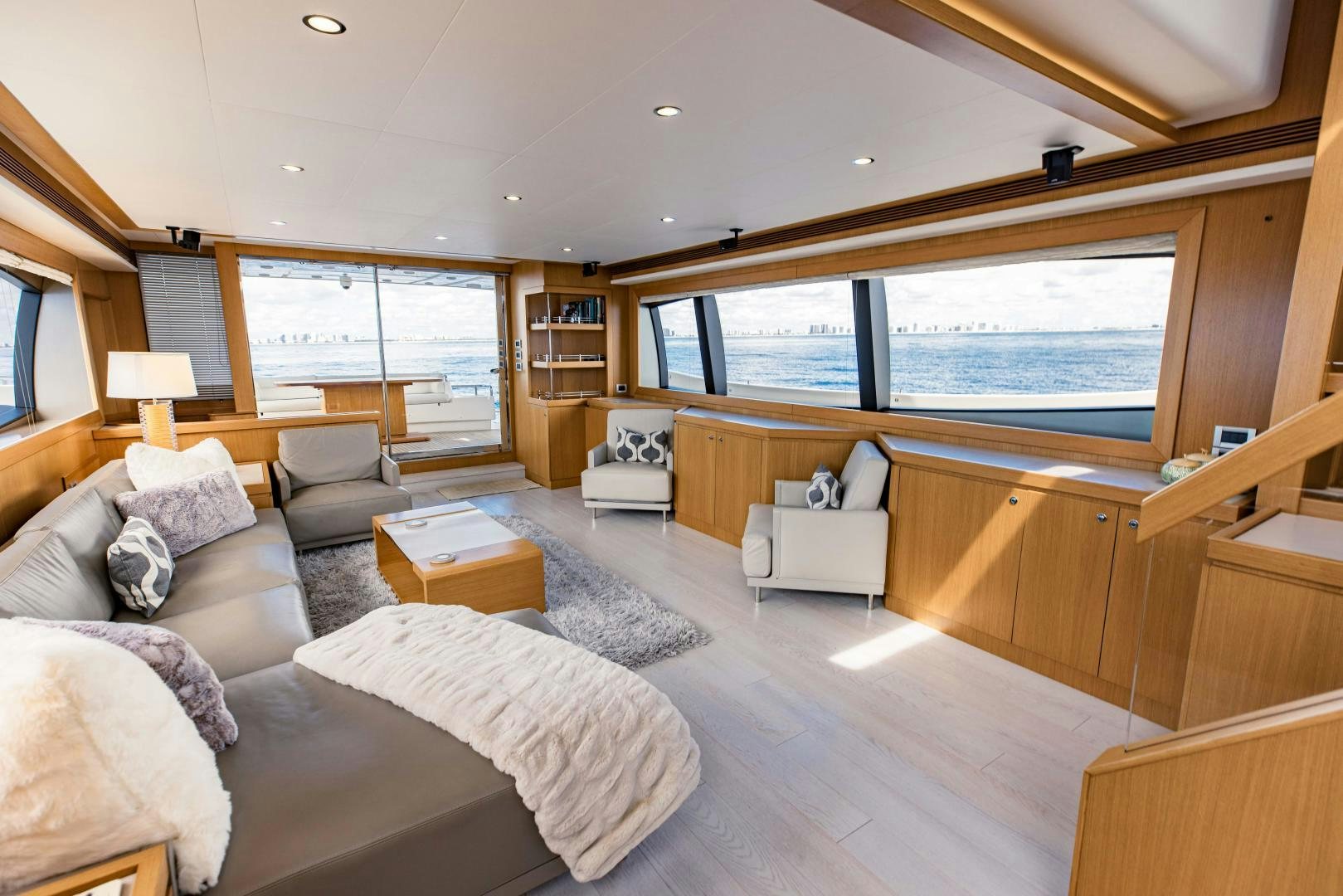 a living room with a large window aboard SHE RUNS WET Yacht for Sale