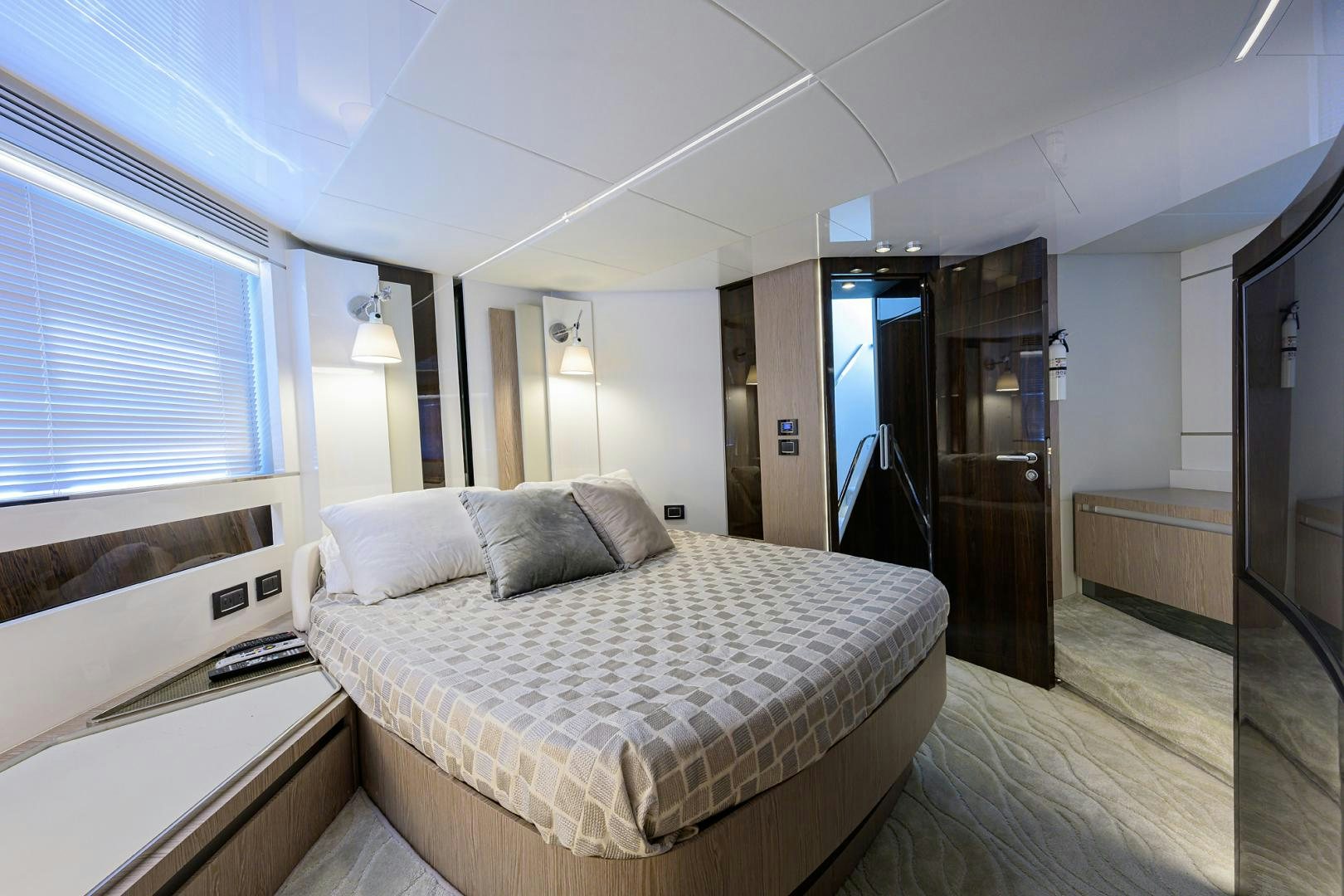 a bedroom with a bed and a door aboard CRIMSON Yacht for Sale