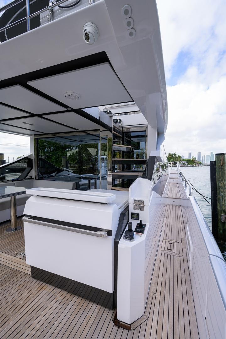 a deck with a large white boat on it aboard CRIMSON Yacht for Sale