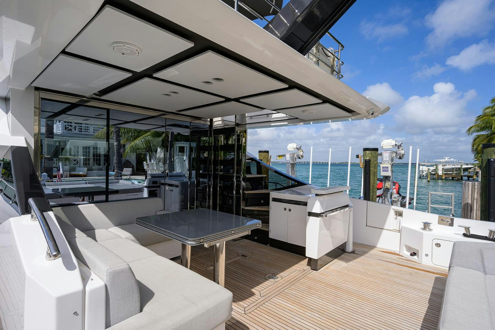 a room with a pool and a deck with a large deck and a large pool and a large aboard CRIMSON Yacht for Sale