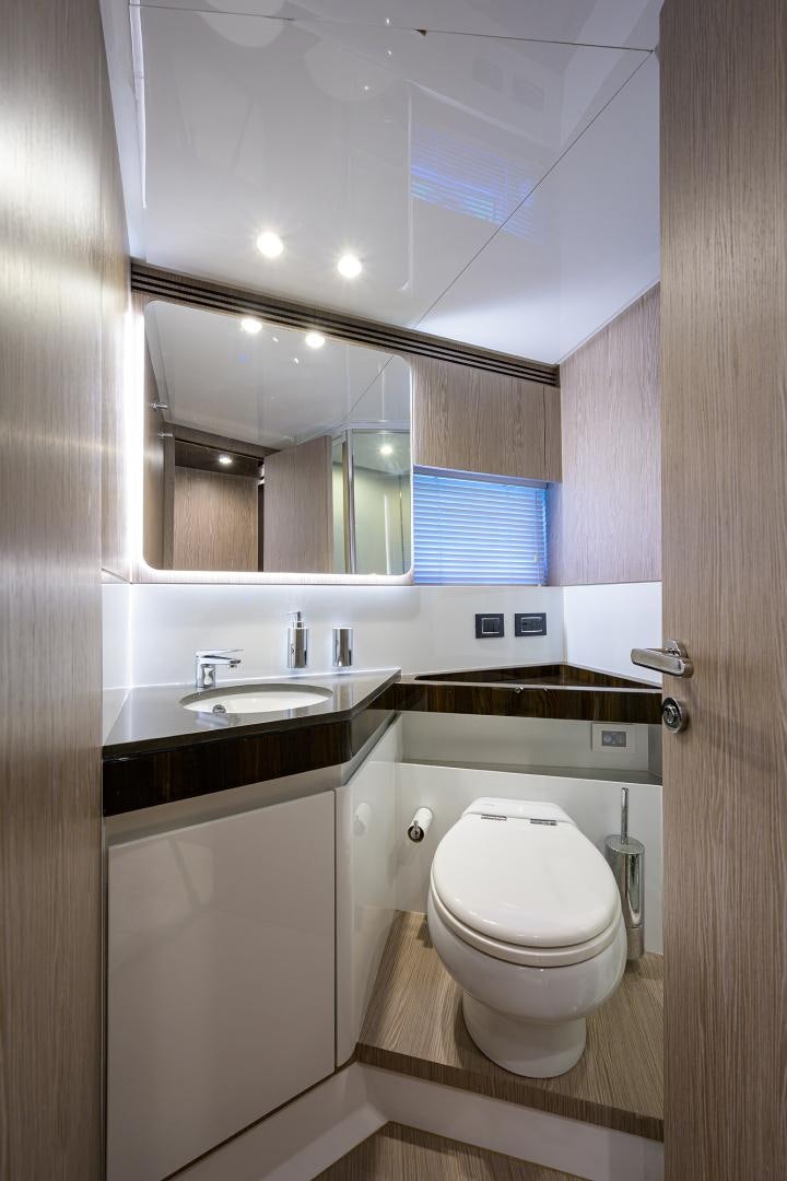 a bathroom with a toilet and a sink aboard CRIMSON Yacht for Sale