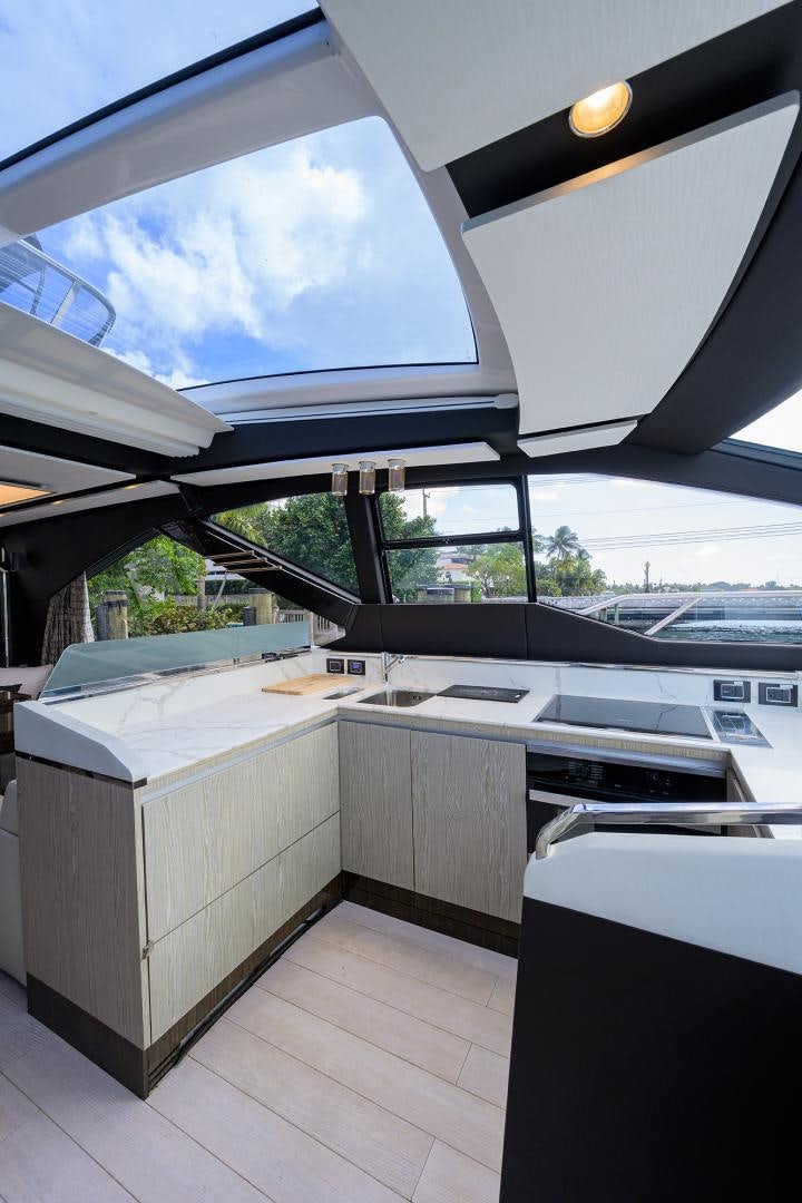 a kitchen with a large window aboard CRIMSON Yacht for Sale