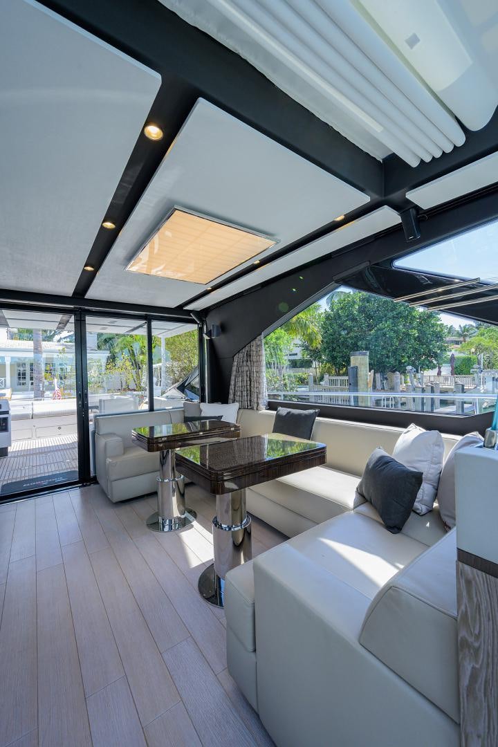 a room with a table and couches aboard CRIMSON Yacht for Sale