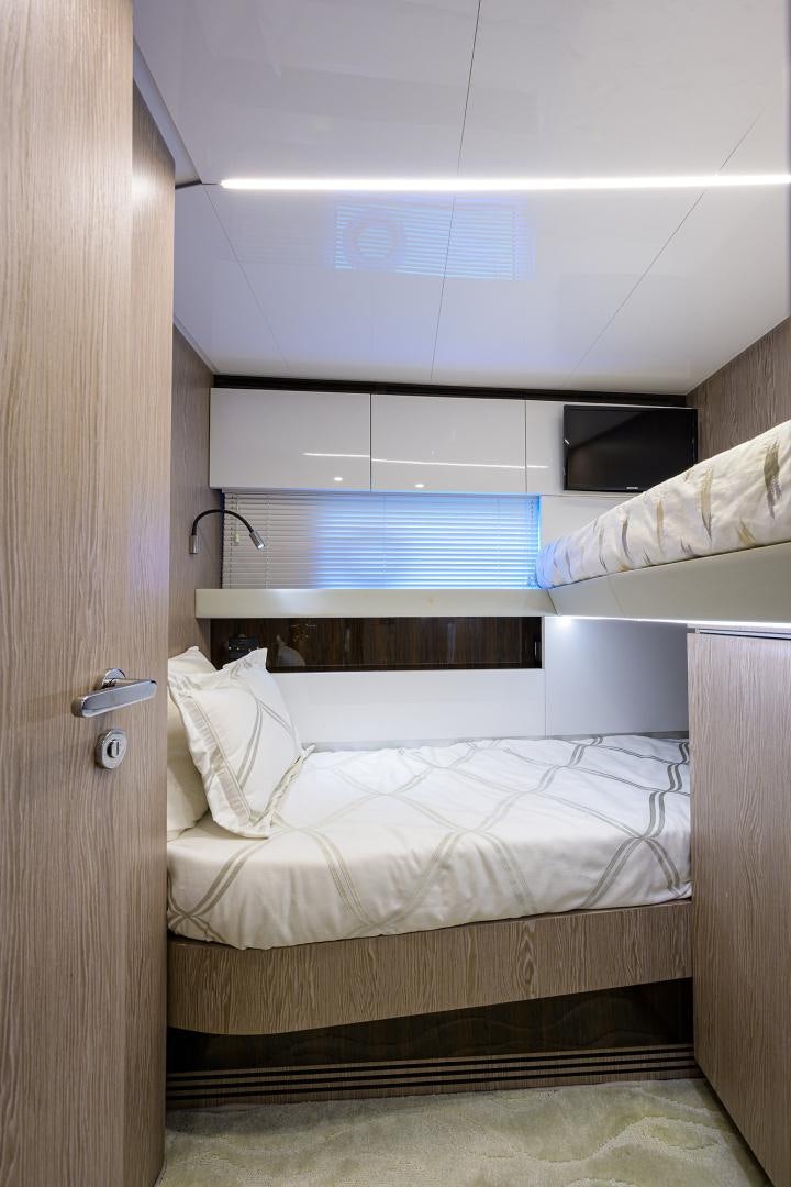 a room with a bed and a closet aboard CRIMSON Yacht for Sale