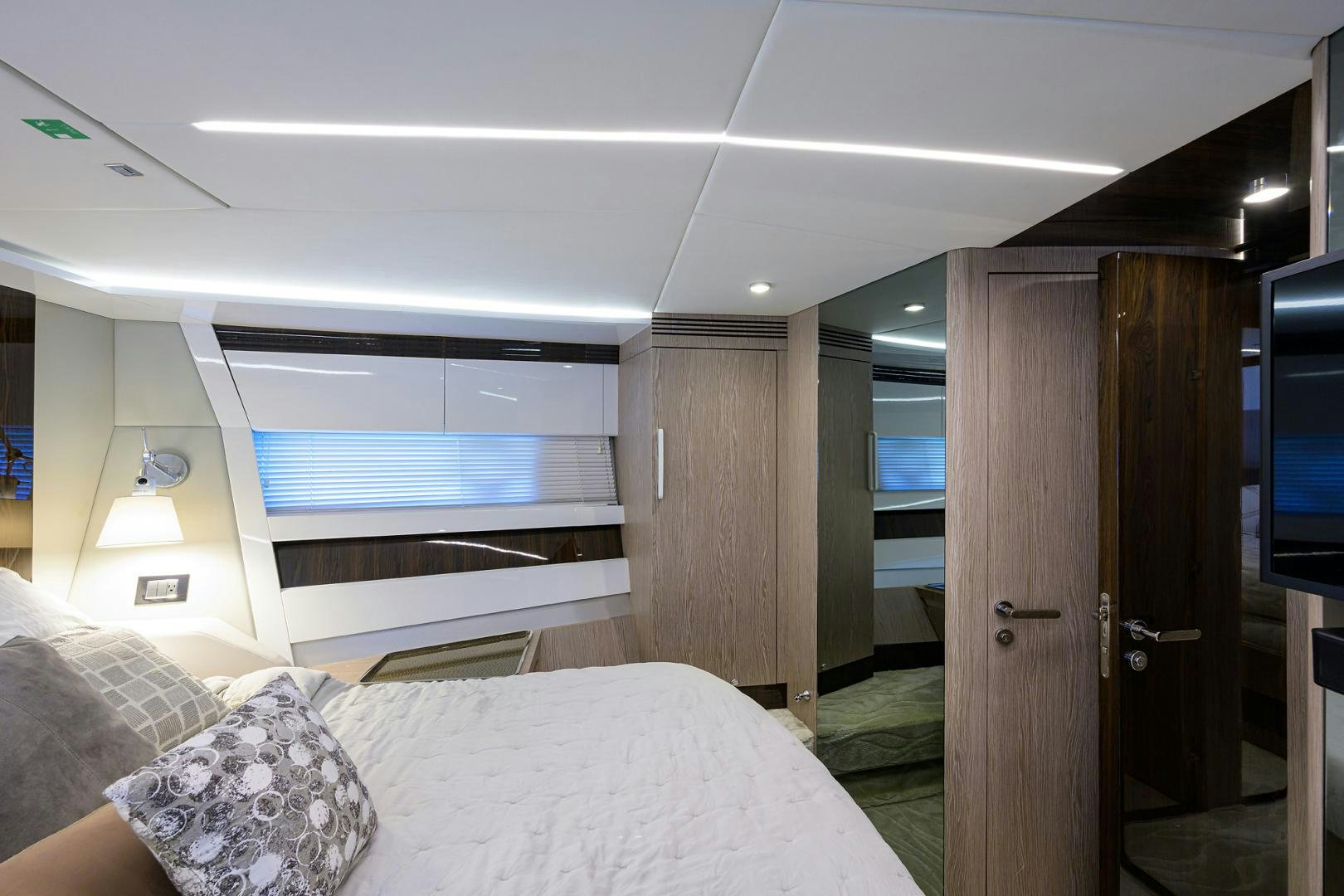 a bedroom with a bed and a closet aboard CRIMSON Yacht for Sale