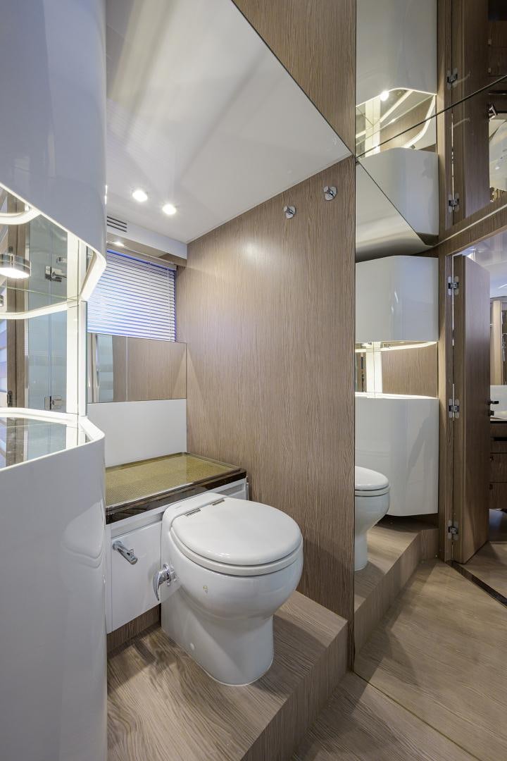 a bathroom with a toilet and a sink aboard CRIMSON Yacht for Sale