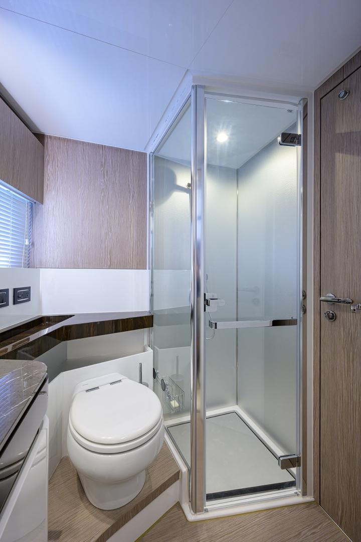 a bathroom with a glass shower aboard CRIMSON Yacht for Sale