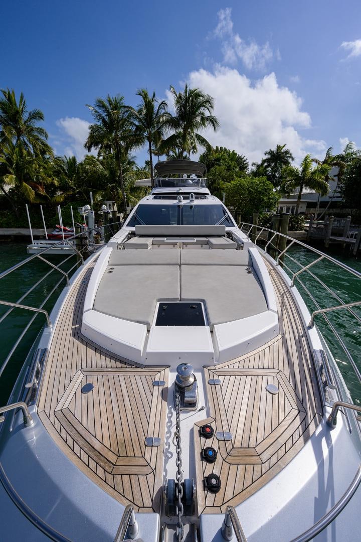 a white boat on a dock aboard CRIMSON Yacht for Sale