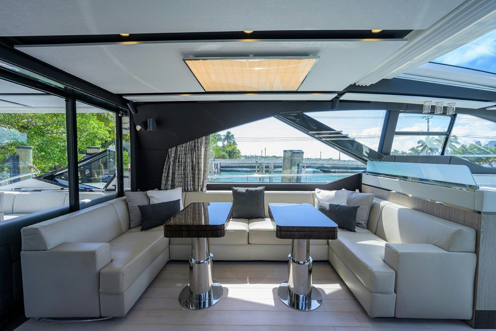 a living room with a large window aboard CRIMSON Yacht for Sale