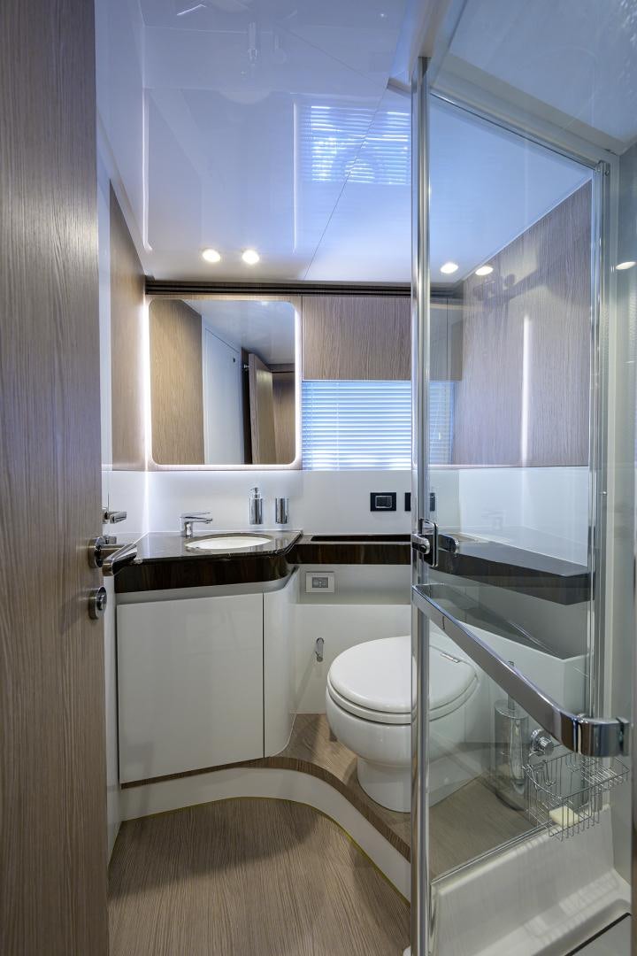 a bathroom with a glass shower door aboard CRIMSON Yacht for Sale