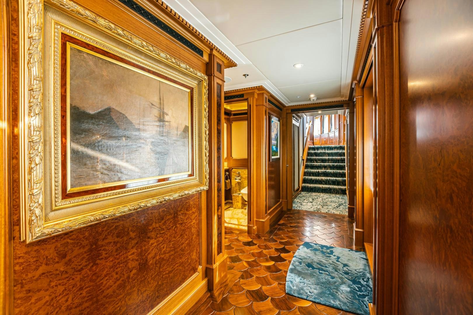 a hallway with a painting on the wall aboard GALLANT LADY Yacht for Sale