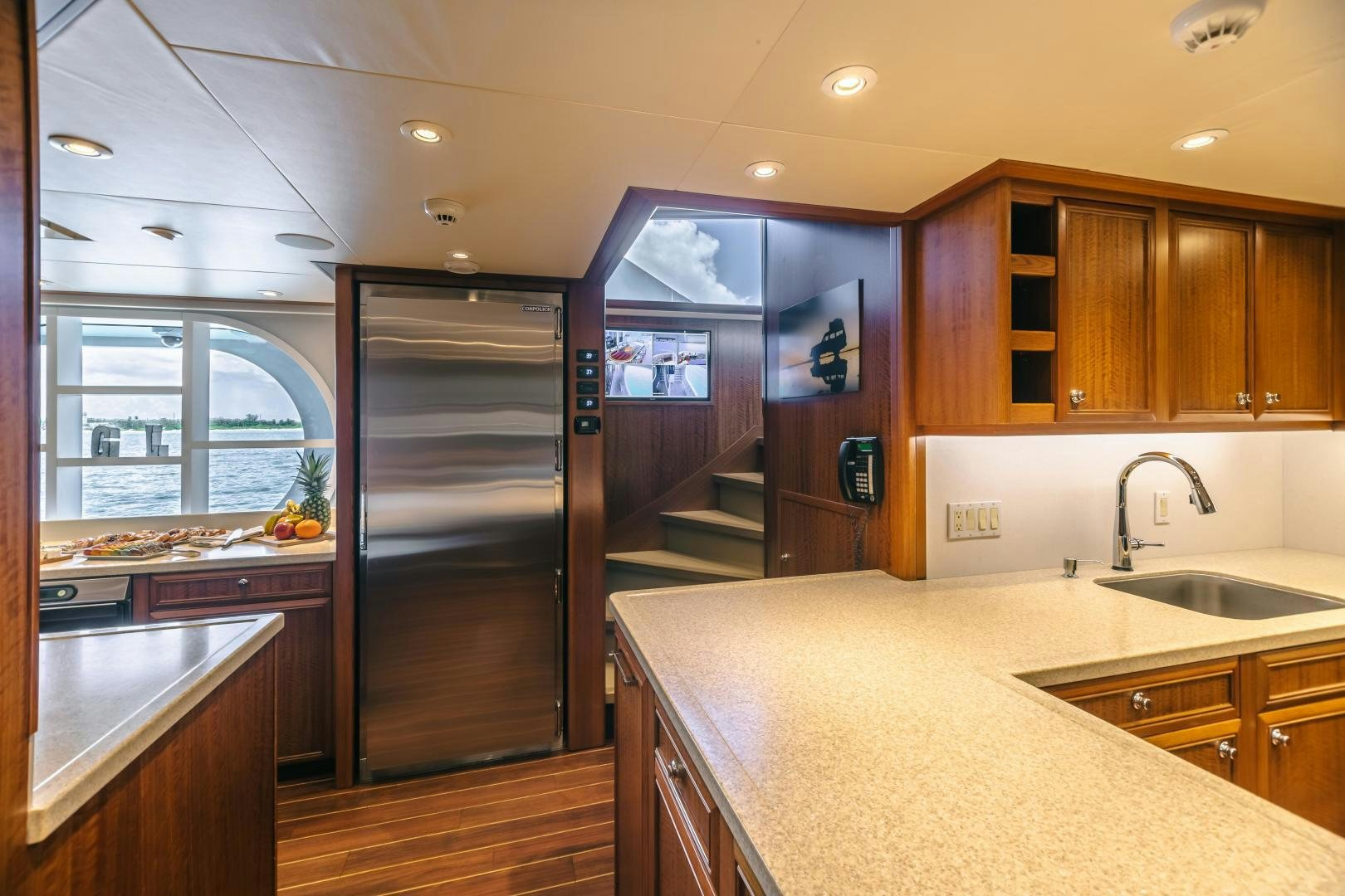 a kitchen with wooden cabinets aboard GALLANT LADY Yacht for Sale