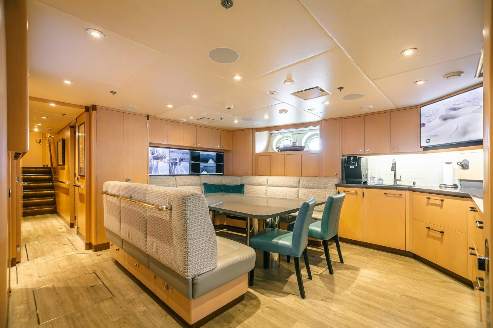a large kitchen with a couch aboard GALLANT LADY Yacht for Sale