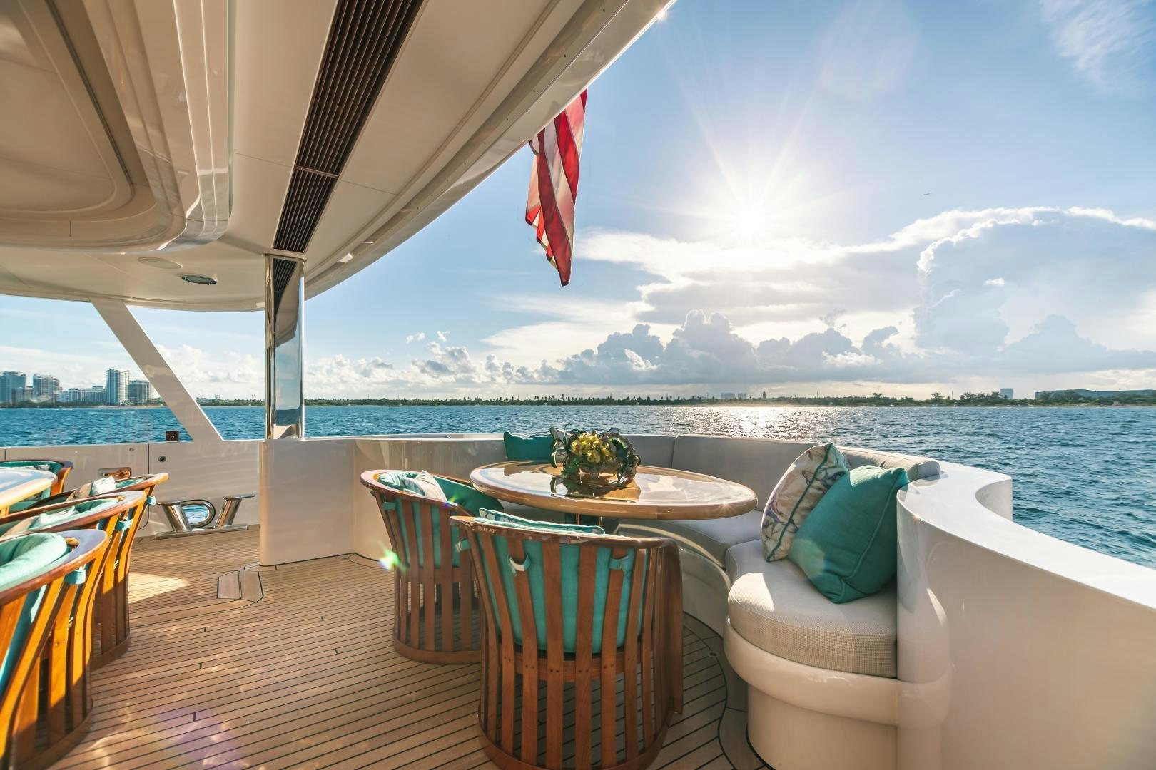 a deck with a table and chairs on it aboard GALLANT LADY Yacht for Sale