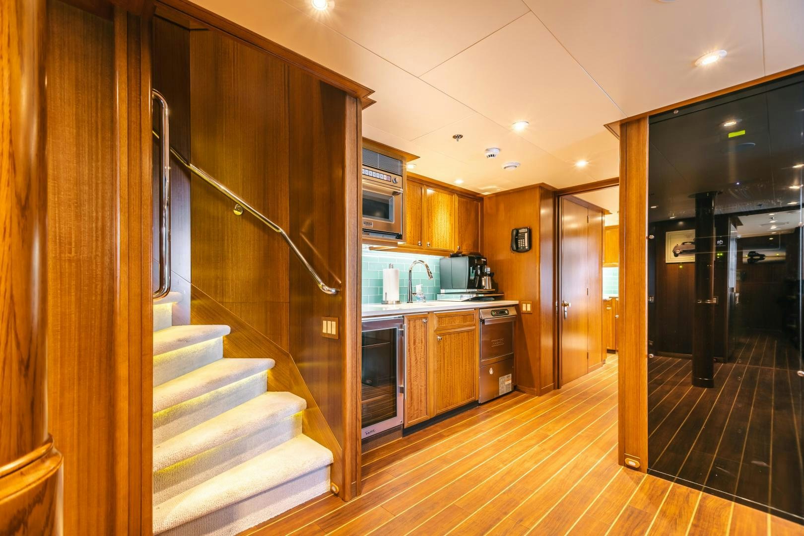 a kitchen with a staircase and a staircase aboard GALLANT LADY Yacht for Sale