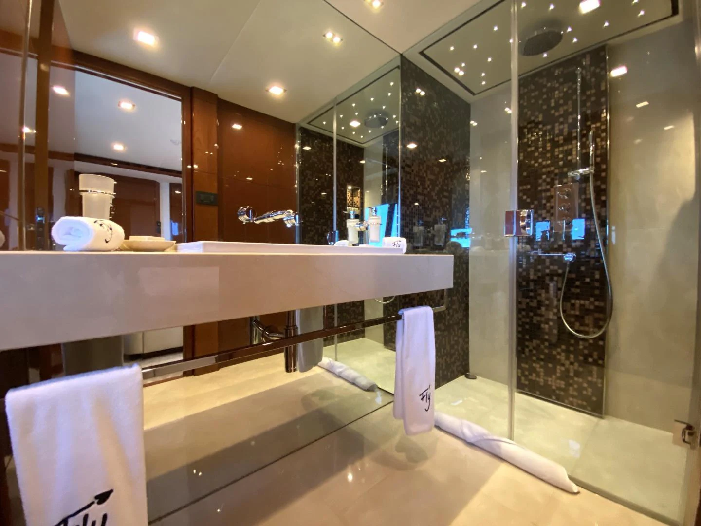 a bathroom with a large glass shower aboard M/Y FLY Yacht for Sale