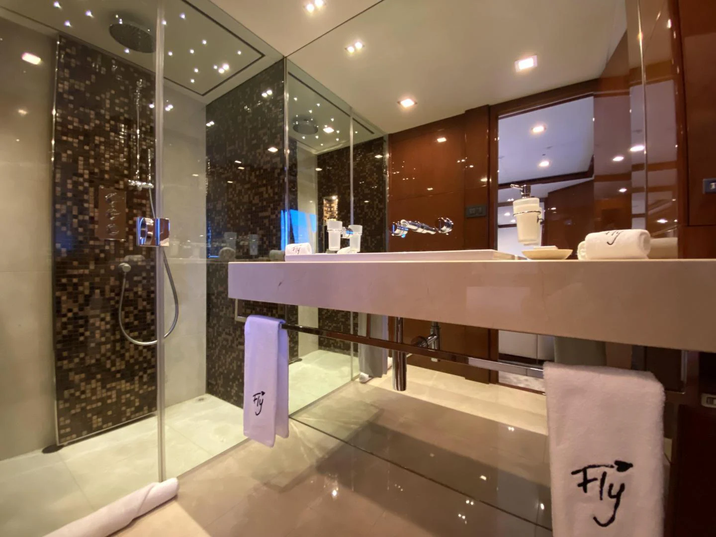 a bathroom with a glass shower aboard M/Y FLY Yacht for Sale