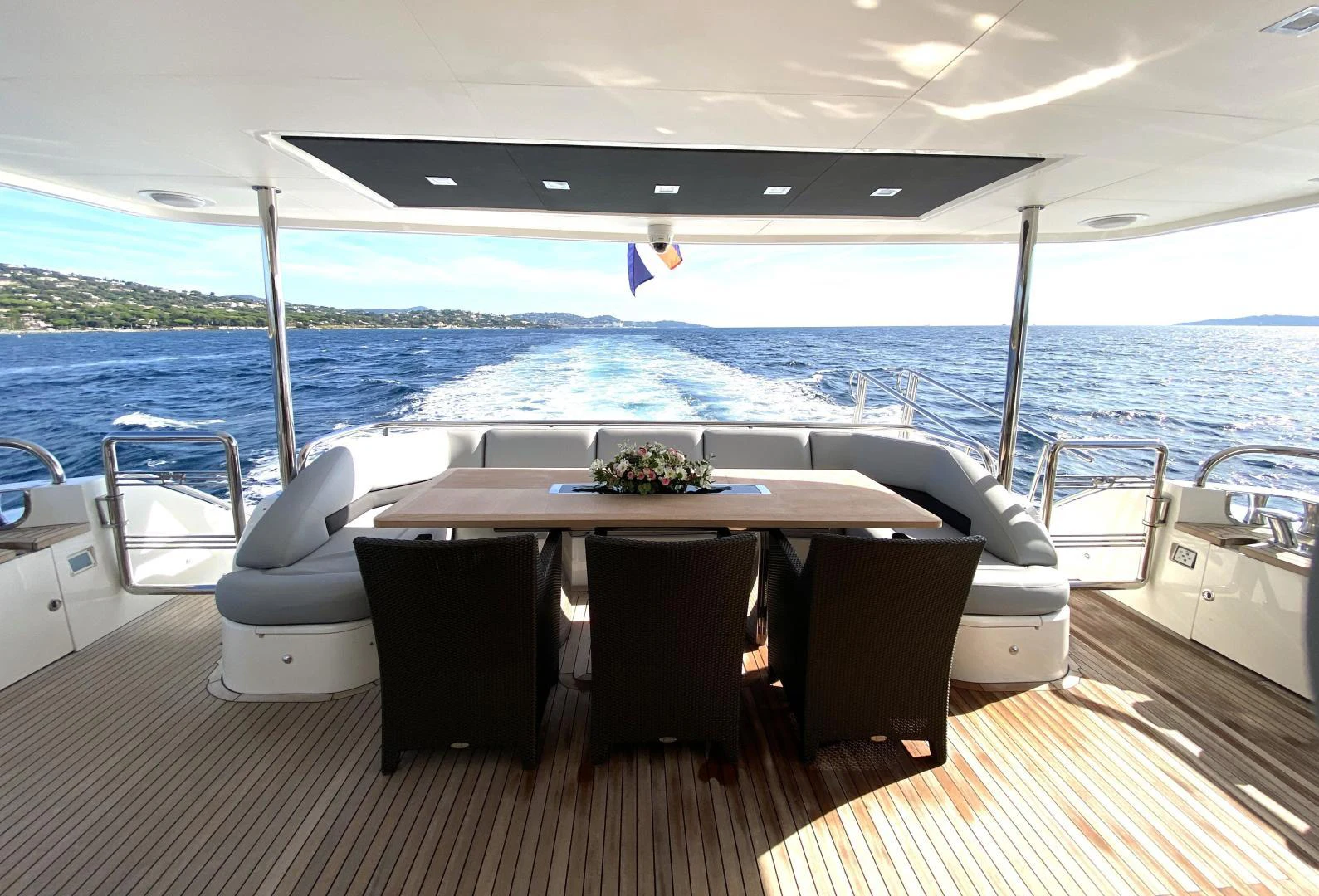 a table on a deck overlooking the ocean aboard M/Y FLY Yacht for Sale