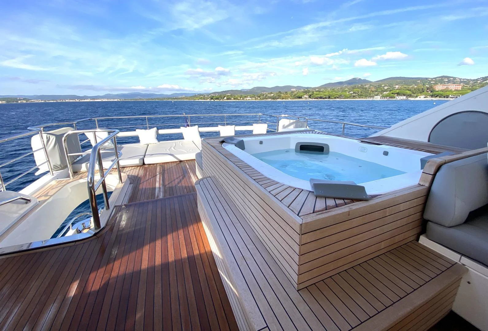 a deck with a view of the ocean and a city aboard M/Y FLY Yacht for Sale