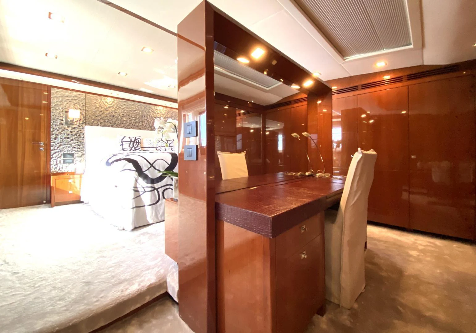 a room with a bed and a chair aboard M/Y FLY Yacht for Sale