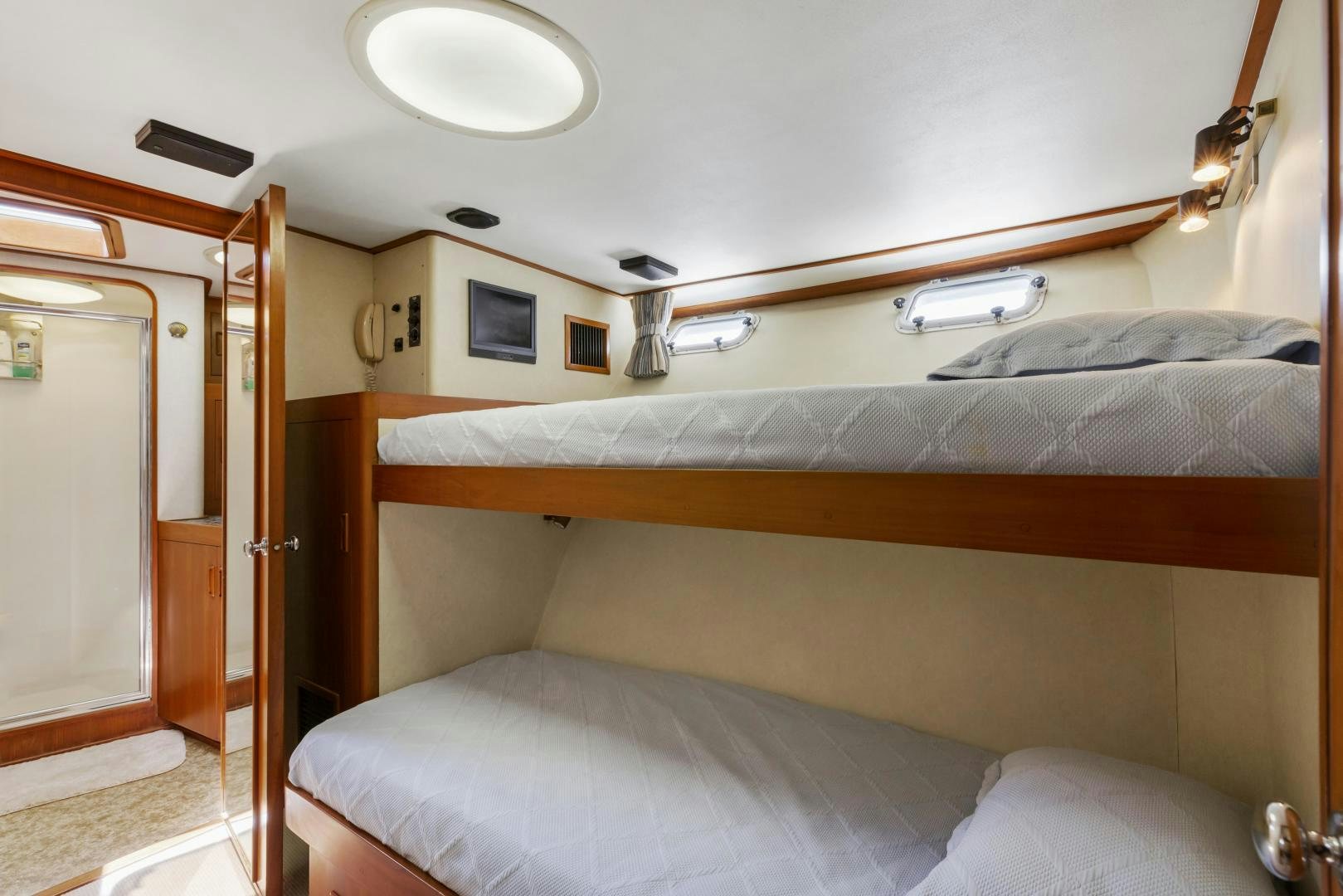 a bed with a wood headboard aboard DON JUAN Yacht for Sale