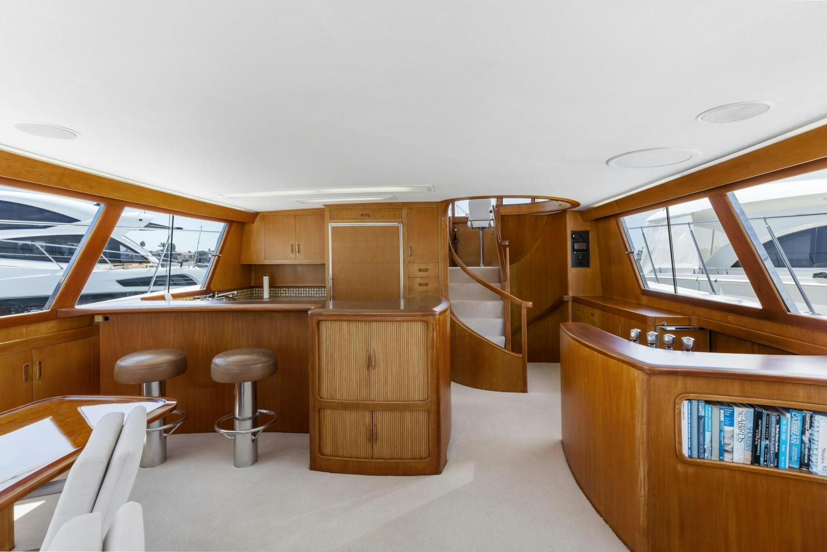 a room with a table and stools and a window aboard DON JUAN Yacht for Sale