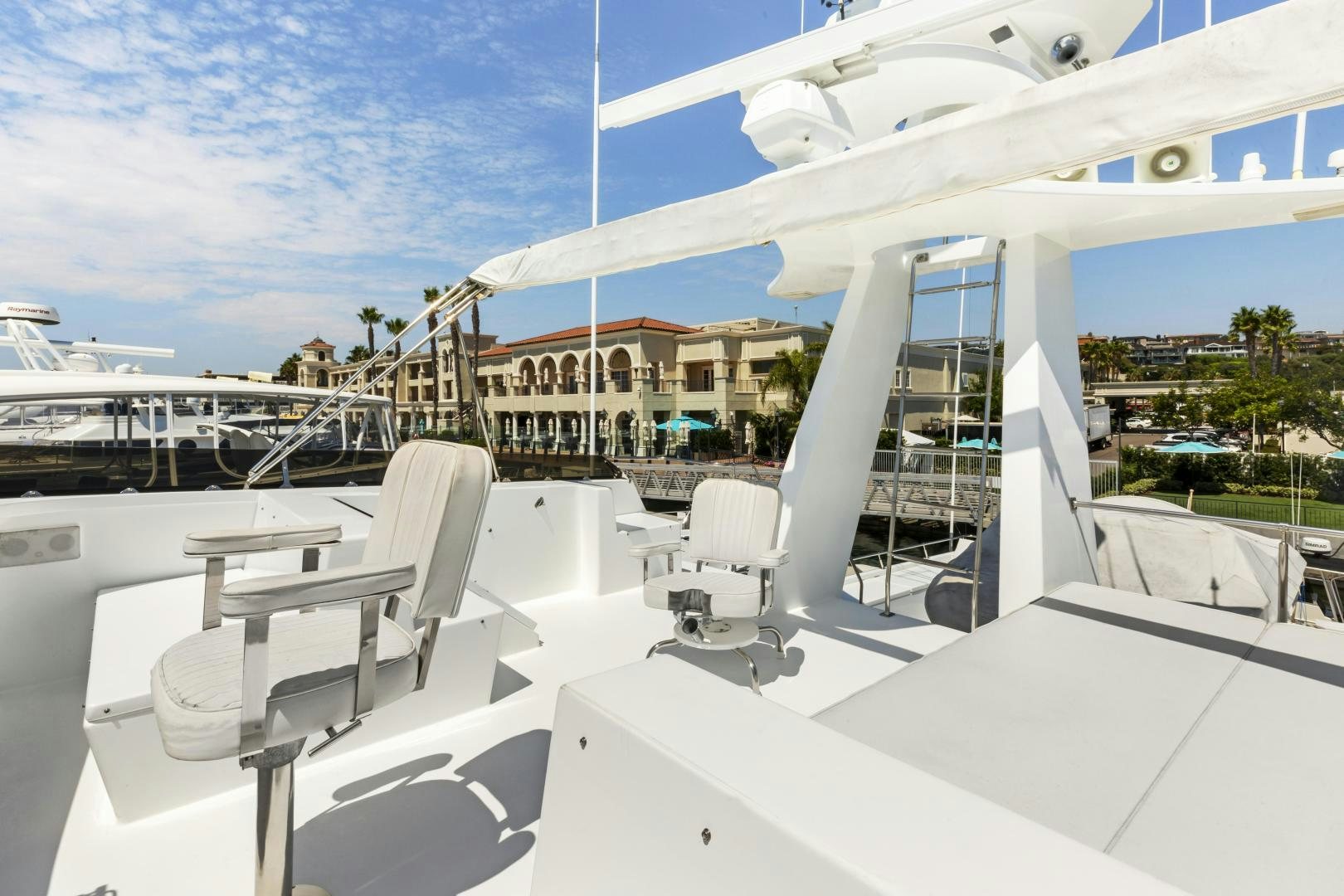 a large white boat with chairs on the deck aboard DON JUAN Yacht for Sale