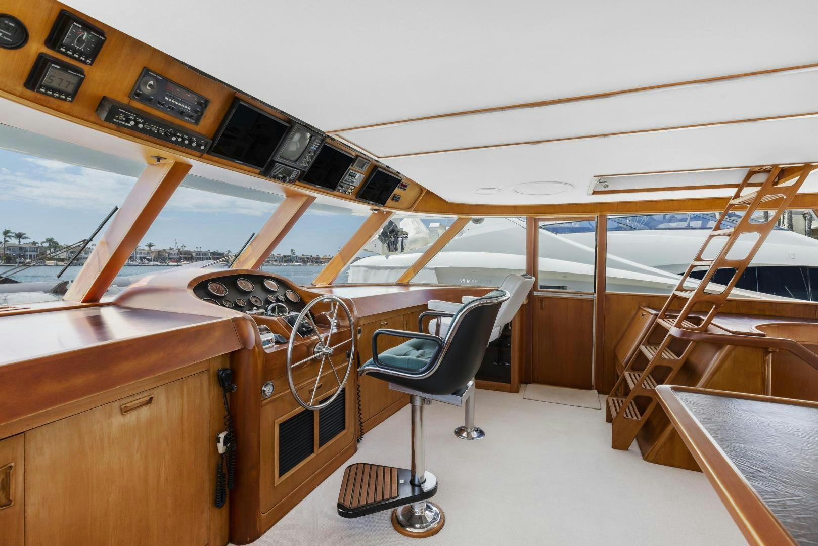 a room with a chair and a table and a large window aboard DON JUAN Yacht for Sale