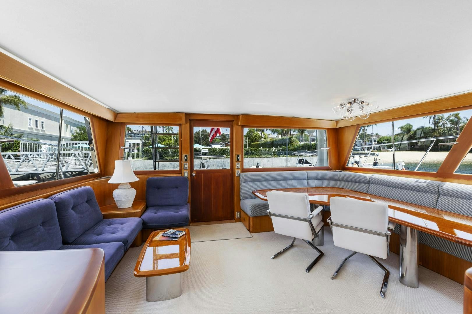a room with a table chairs and a couch aboard DON JUAN Yacht for Sale