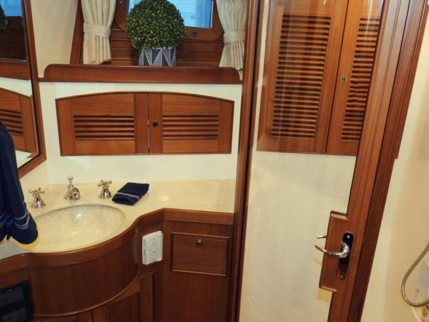a bathroom with a sink and cabinets aboard AGAVE Yacht for Sale