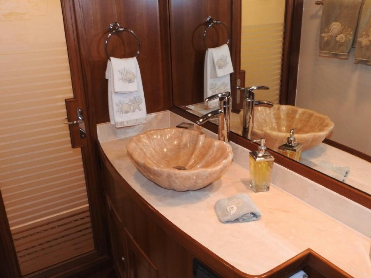 a bathroom with a sink and a mirror aboard AGAVE Yacht for Sale