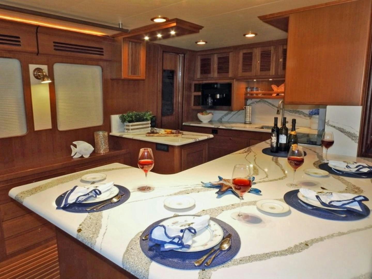 a large kitchen with a large island aboard AGAVE Yacht for Sale