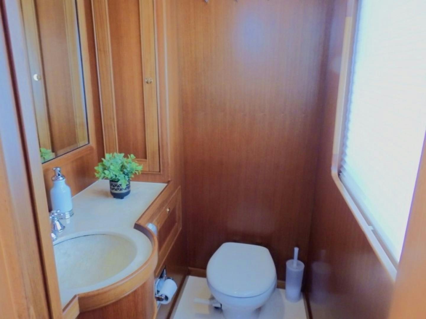 a bathroom with a toilet and a sink aboard AGAVE Yacht for Sale