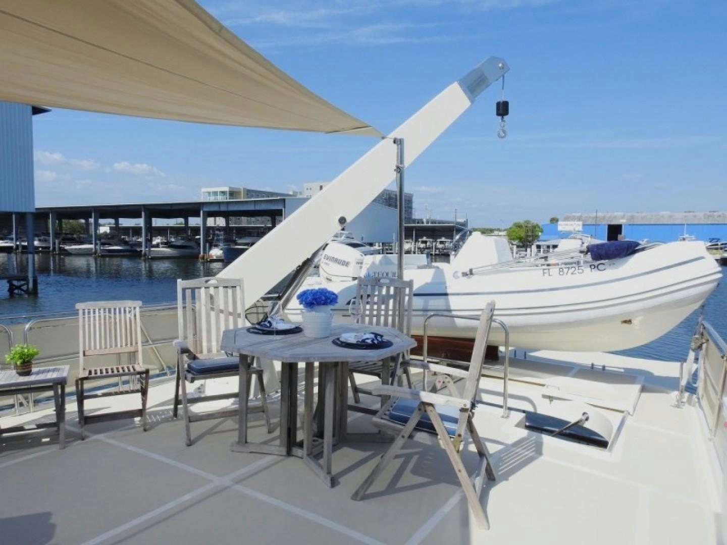 a table and chairs on a deck aboard AGAVE Yacht for Sale