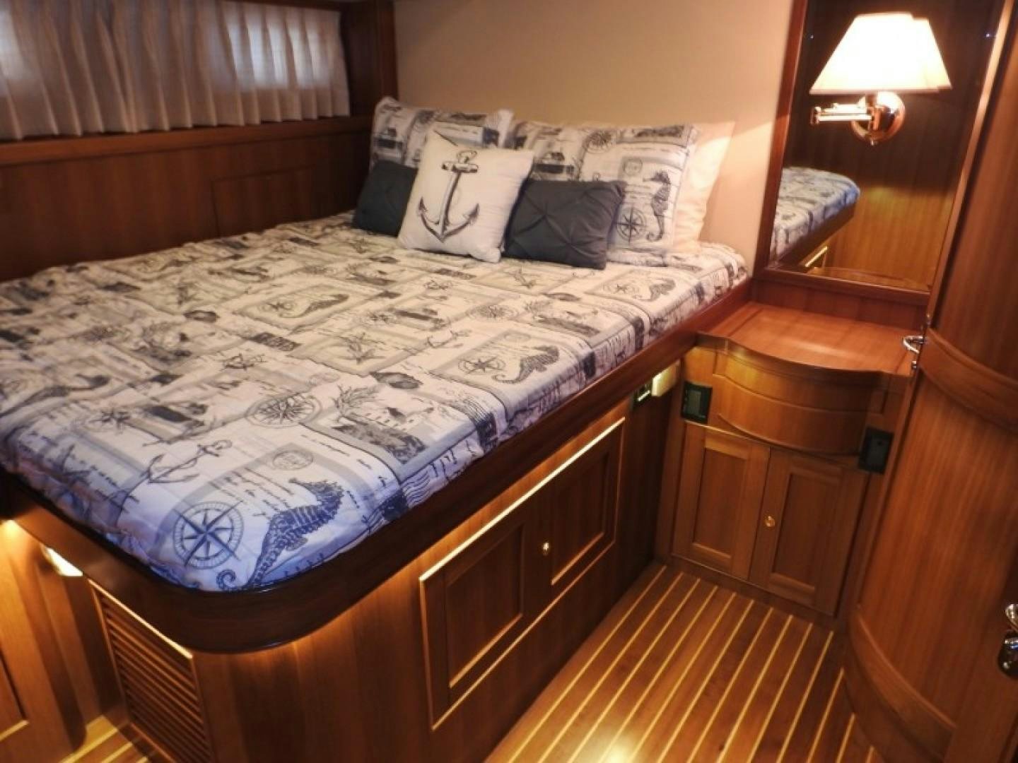 a bed with a white comforter aboard AGAVE Yacht for Sale