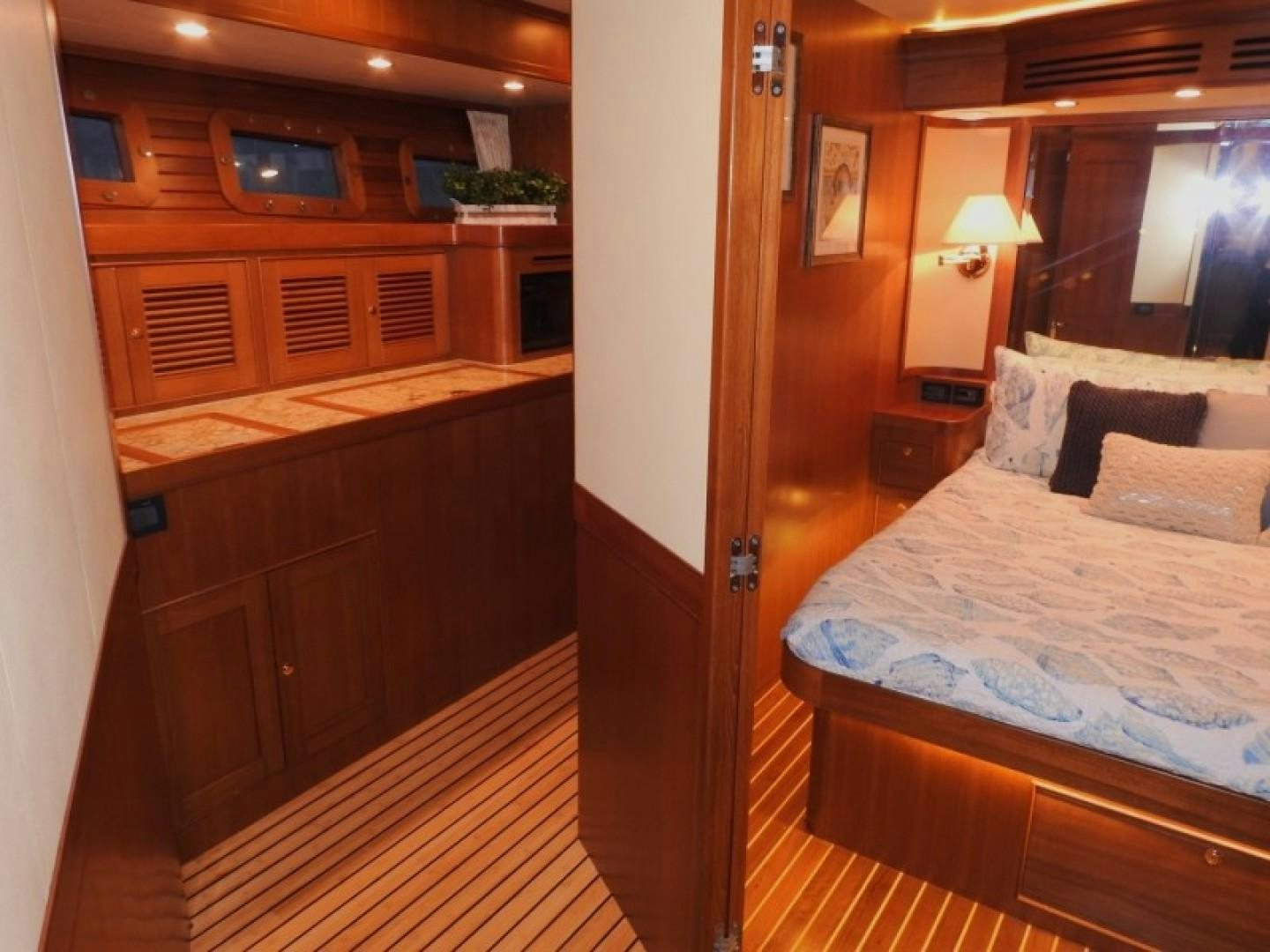 a room with a bed and a desk aboard AGAVE Yacht for Sale
