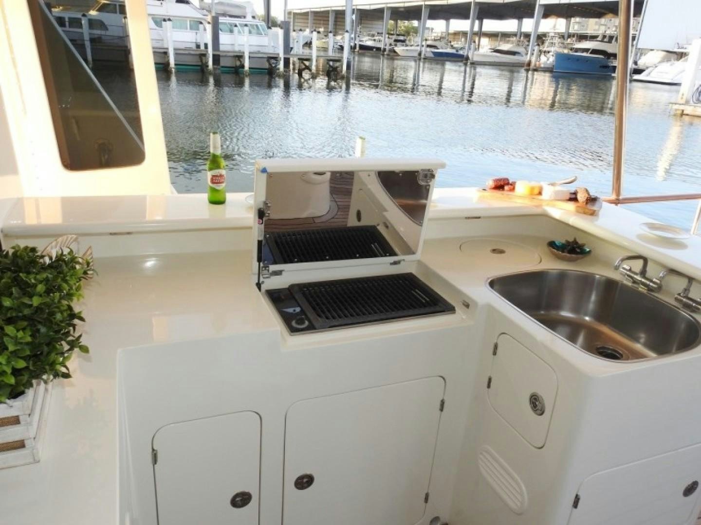 a kitchen with a sink and a laptop on it aboard AGAVE Yacht for Sale