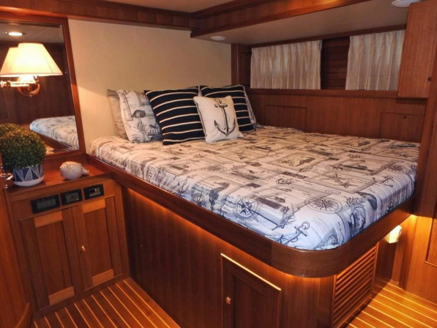 a bed with a black and white comforter and pillows aboard AGAVE Yacht for Sale