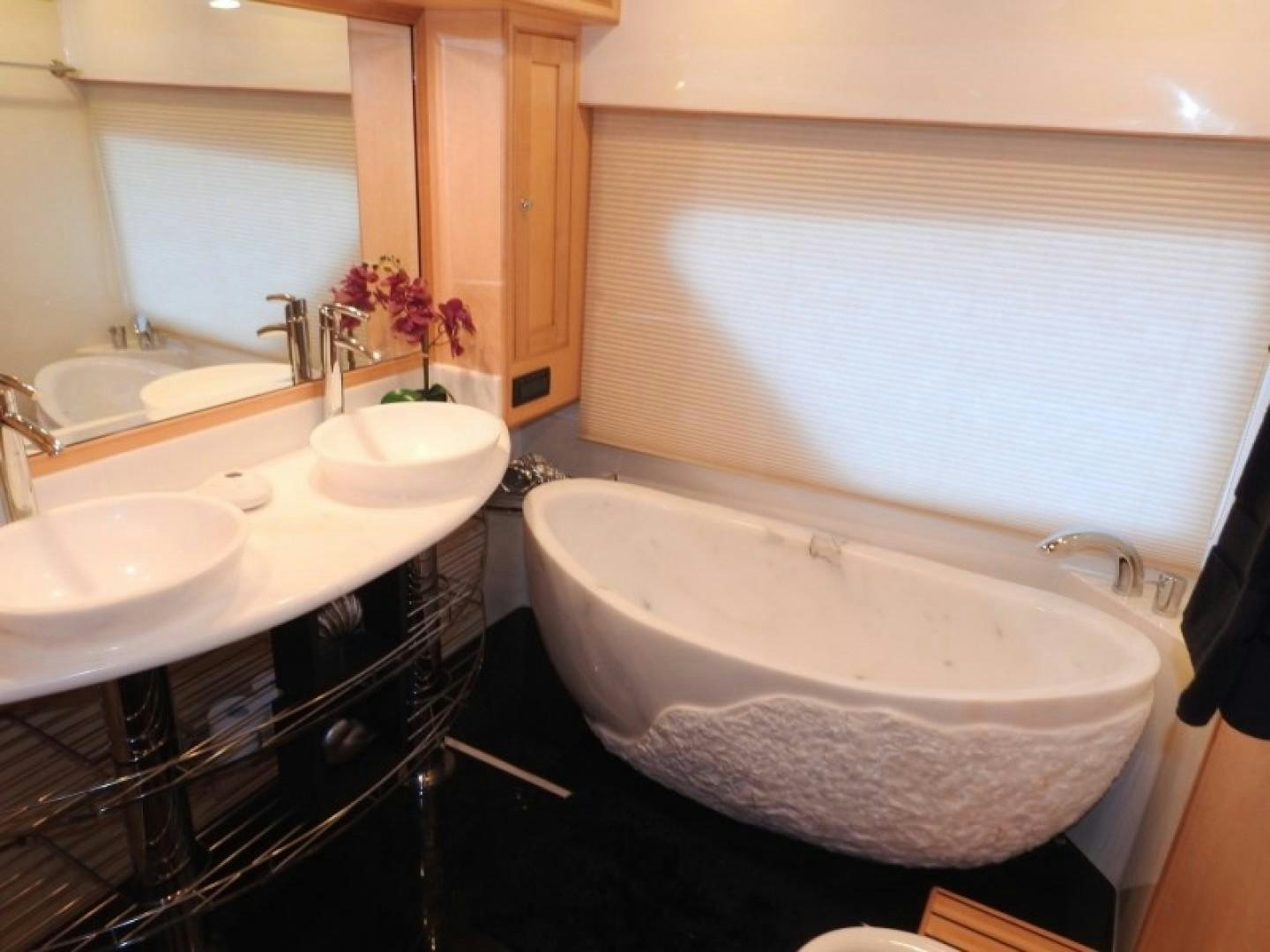 a bathroom with a tub sink and sinks aboard AGAVE Yacht for Sale