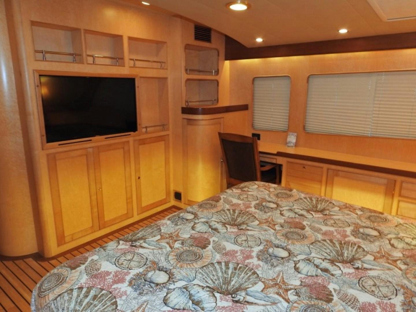 a bedroom with a bed and tv aboard AGAVE Yacht for Sale