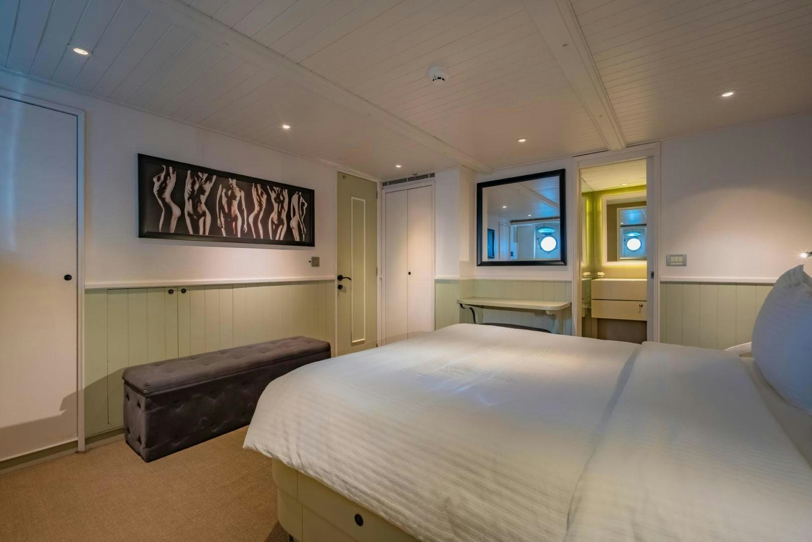 a bedroom with a bed and a television aboard DOUBLEYOU Yacht for Sale