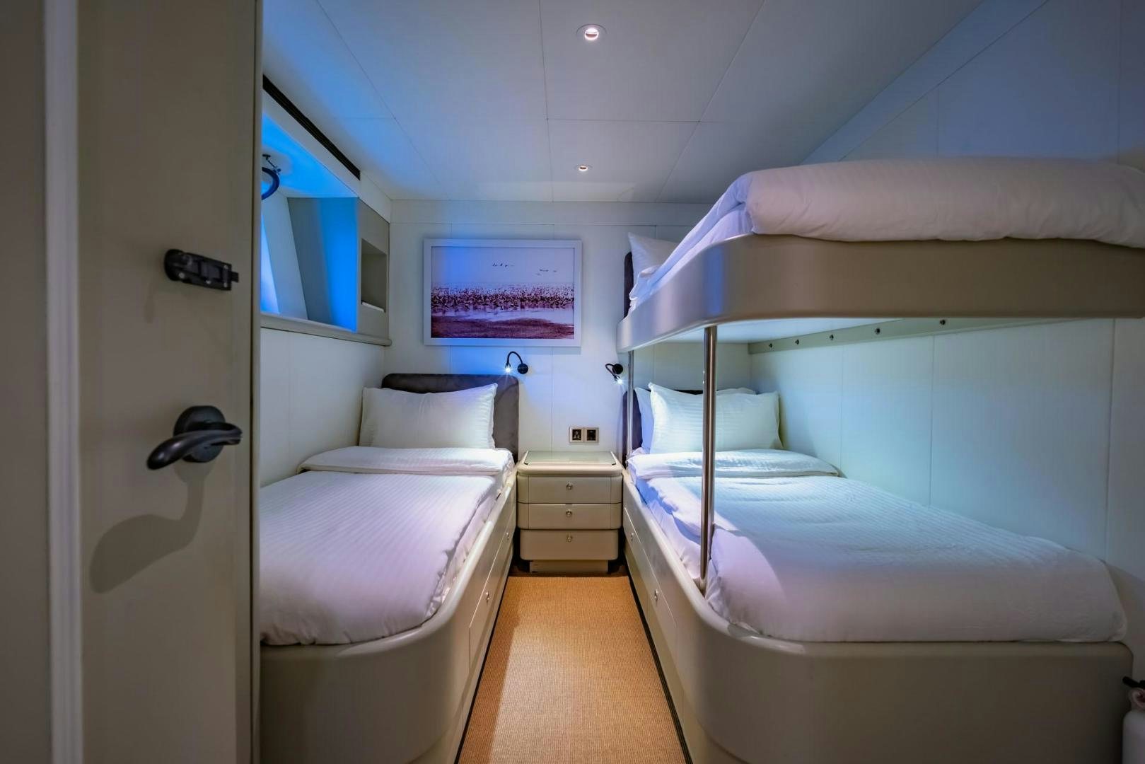 a room with beds and a tv aboard DOUBLEYOU Yacht for Sale