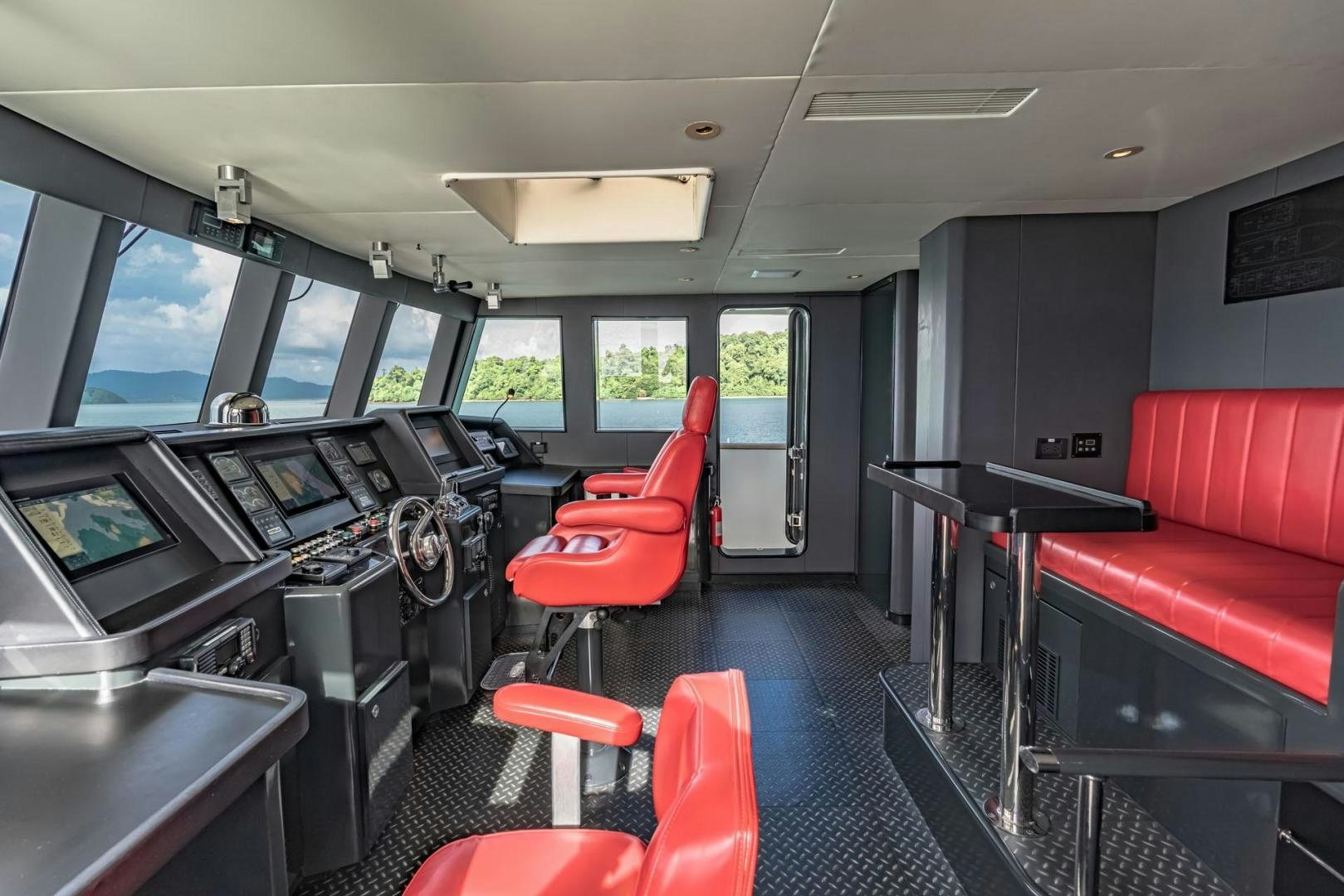 a room with a red couch and a red chair aboard DOUBLEYOU Yacht for Sale